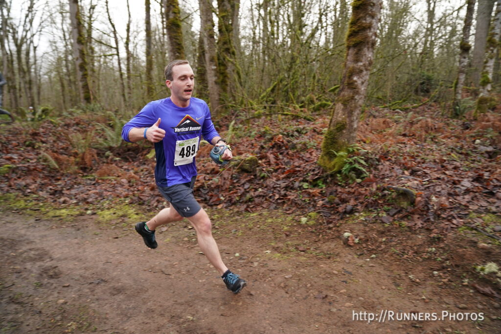 A photo of the author running in a race and giving a big thumbs-up!